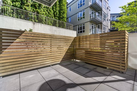a wooden privacy fence in front of an apartment complex  at 128 on State, Washington